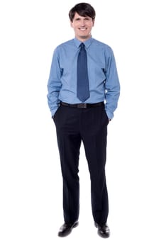 Corporate executive posing with hands in pockets