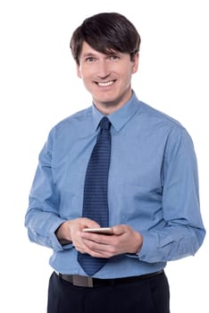 Smiling executive posing with his smart phone
