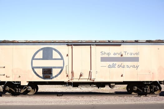 The side view of a disused railway wagon on a rail.