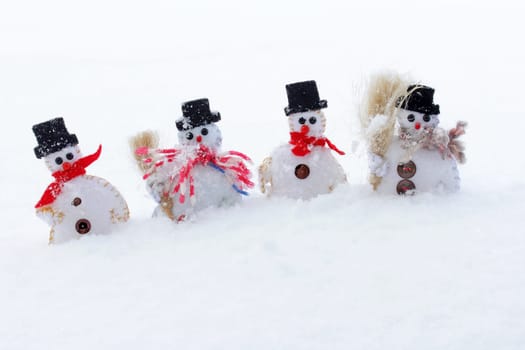 Four snowmen in the cold snow