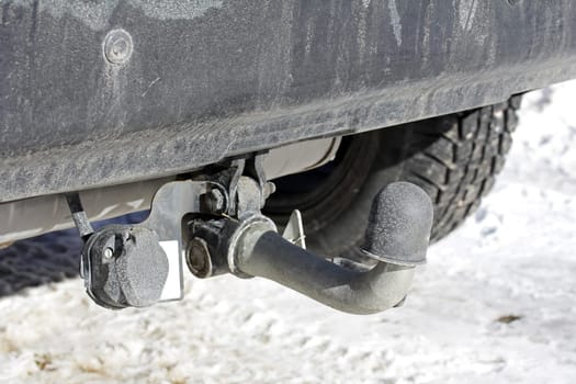 Trailer coupling on a car with protective cap in winter