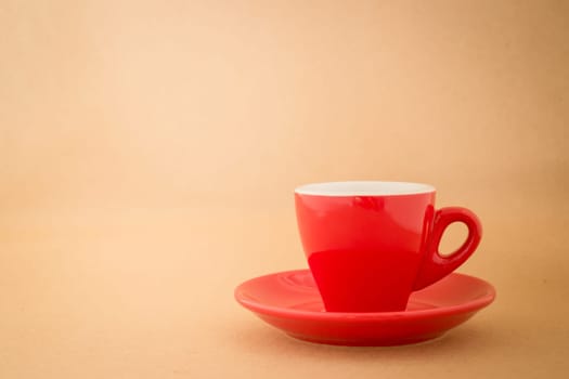 Beautiful red cup of coffee on vintage background, stock photo