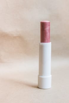 Moisturizer lipstick on brown natural background, stock photo
