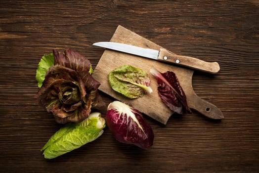 Fresh mixed radicchio on a wooden background.