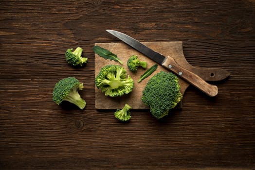 Fresh raw broccoli on a wooden background overhead shoot.