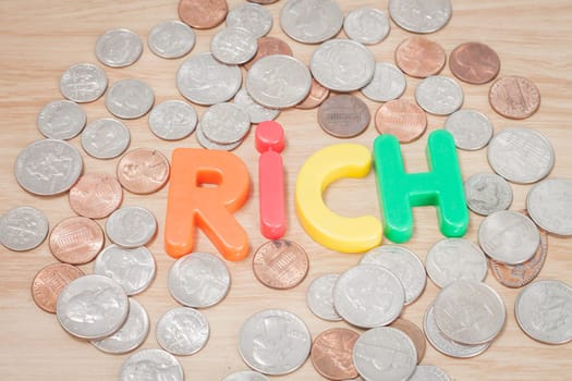 Rich alphabet with various US coins, stock photo
