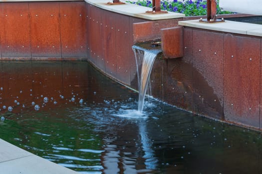 Gardeningly designed water inlet for a garden pond.
