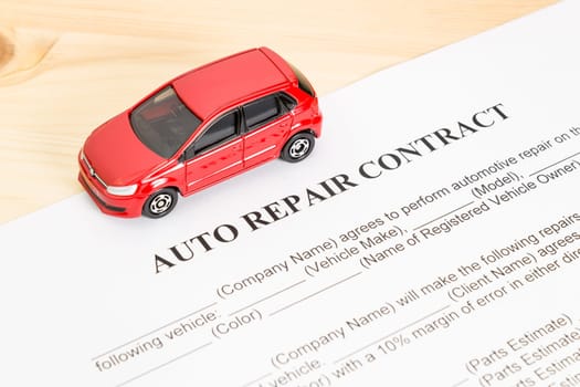 Auto repair contract with red car on left view. Car repair agreement or legal document
