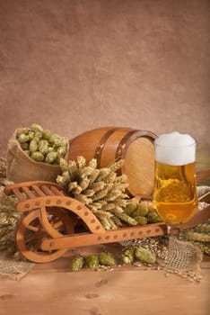 Beer glass with barrel,wheelbarrow,wheat,barley,hops and malt