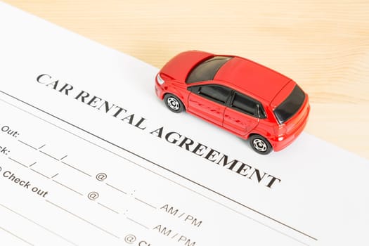 Car rental agreement with red car on right view. Auto rental agreement or legal document