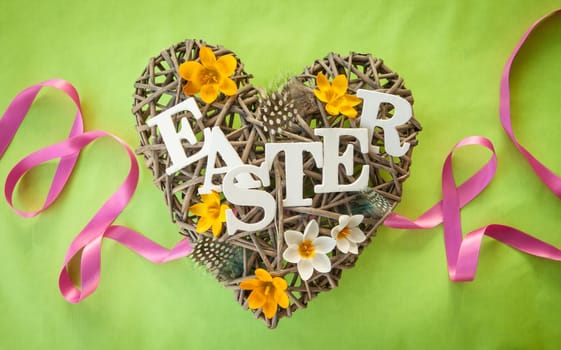 Heart of branches with feathers and crocus at Easter