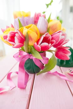 Froehliches bouquet with fresh colorful tulips in Easter egg