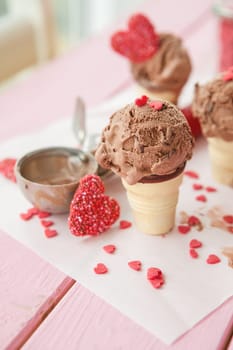 Chocolate ice cream in balls in small waffle cups