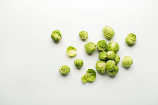 Fresh raw Brussels sprouts isolated on a white background.