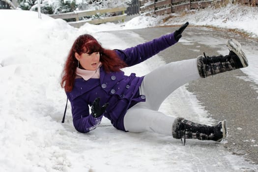 Risk of accident in winter - A woman has slipped on a snow-smooth road