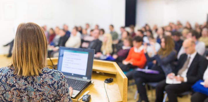 Female speaker at Business Conference and Presentation. Audience at the conference hall. Business and Entrepreneurship. Business woman. Horizontal composition.
