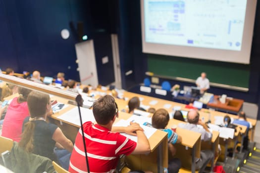 Conference and Presentation. Audience at the conference hall. Business and Entrepreneurship. Faculty lecture and workshop. Audience in the lecture hall. Academic education. Students making notes.