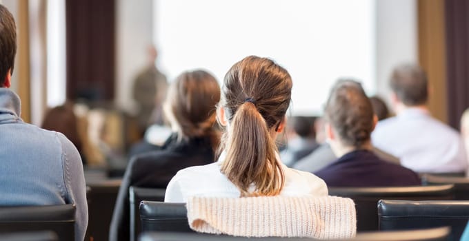 Speaker Giving a Talk at Business Meeting. Audience in the conference hall. Business and Entrepreneurship. Panoramic composition suitable for banners.