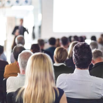 Speaker Giving a Talk at Business Meeting. Audience in the conference hall. Business and Entrepreneurship. Square composition.