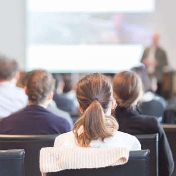 Speaker Giving a Talk at Business Meeting. Audience in the conference hall. Business and Entrepreneurship. Square composition.