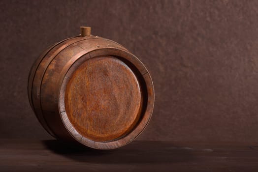 Old wooden barrel with copper rings and wooden plugs