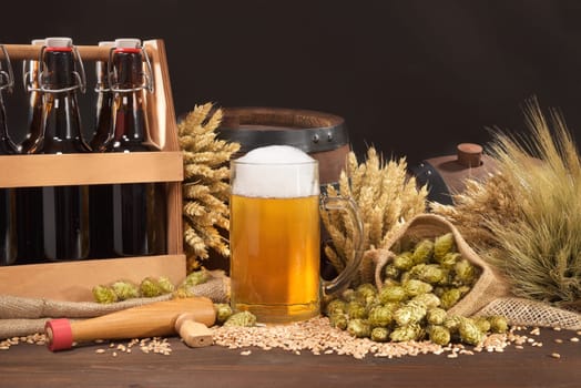 Beer carriers,beer barrels and beer glasses with wheat,barley,hops and malt