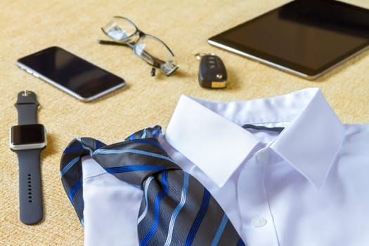 Business, style, clothes and objects concept - close up of formal male clothes and personal stuff at home.