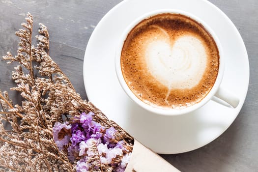 Coffee cup with beautiful violet flower, stock photo