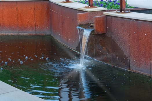 Gardeningly designed water inlet for a garden pond.