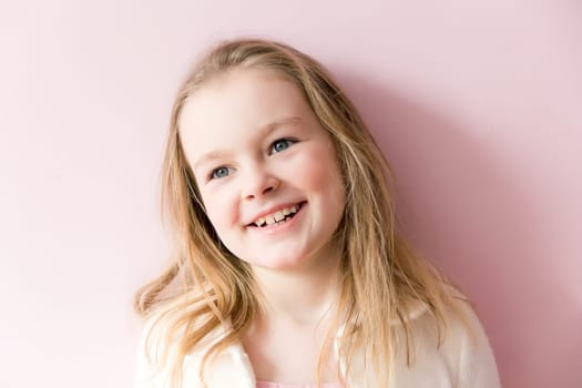 Portrait of cute smiling girl with blond hair