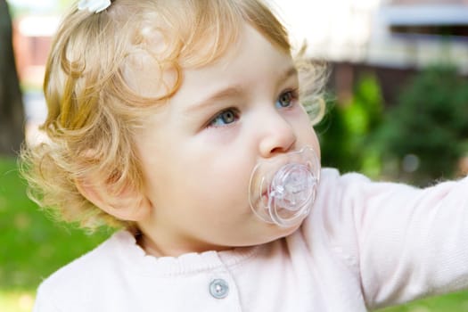 Image of cute baby girl suckle nipple