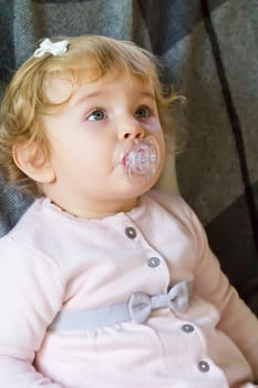 Image of cute baby girl suckle nipple