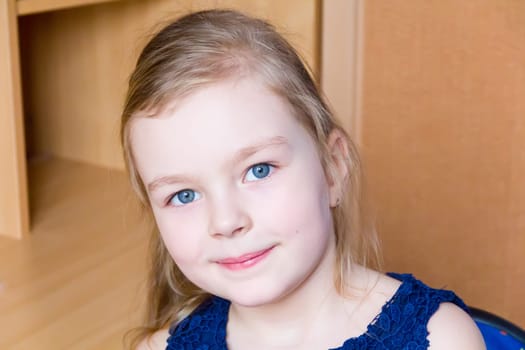 Portrait of cute girl with blond hair