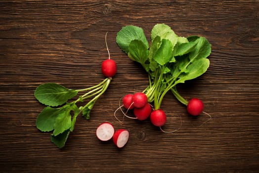 Fresh red radish on wooden background close up