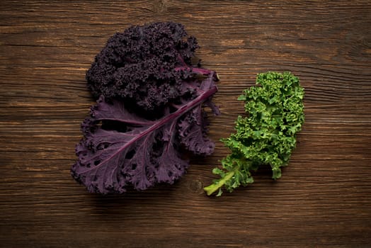 Fresh kale leaf on wooden background close up