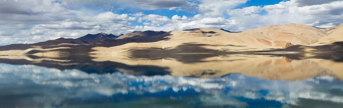 Tsomoriri mountain lake panorama with mountains and blue sky reflections in the lake (Ladakh, India)