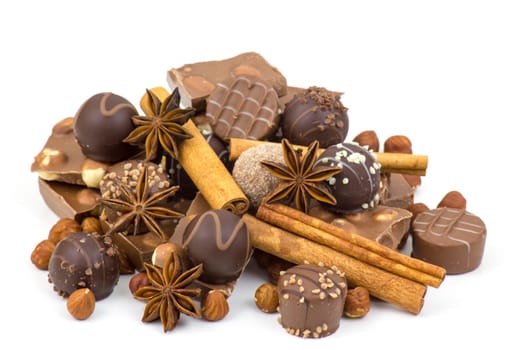 chocolate, spices and nuts on white background