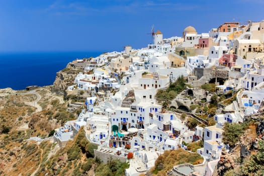 View of colorful Oia village on Santorini island by beautiful day, Greece