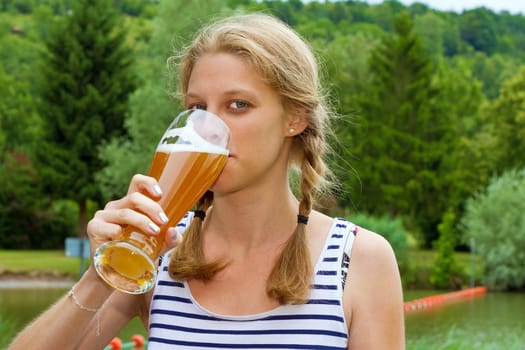 Young woman drinking beer