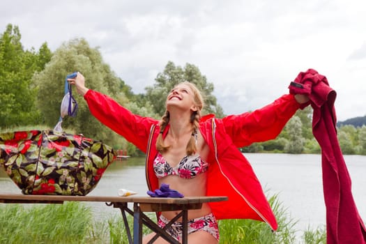 Young happy woman at the lake