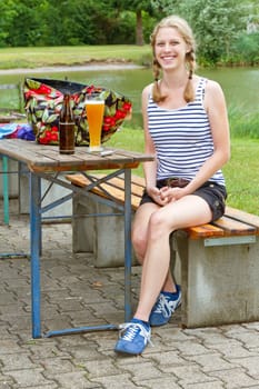 Young woman with beer in the beer garden