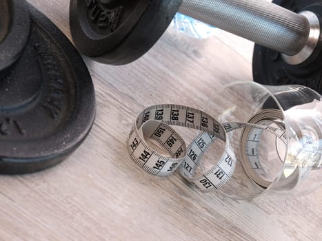 fitness shake with dumbbells and measuring tape