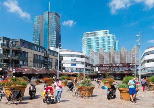 Central train station in Almere, Netherlands on a sunday shopping day. The station opened may 1987 and is designed by Peter Kilsdonk. Under the station lies a bus station