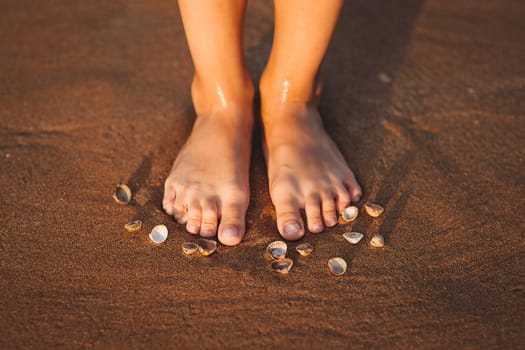 feet on a beach with cockleshells during a decline