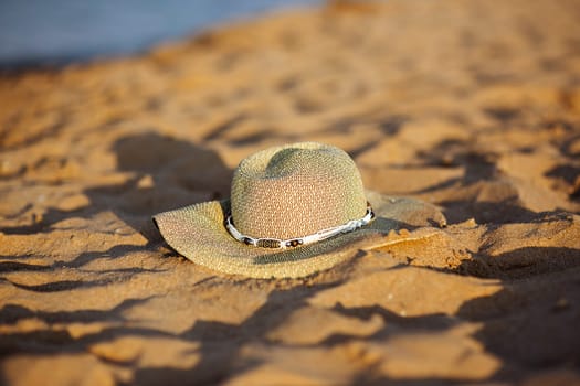 the hat lies on a sandy beach