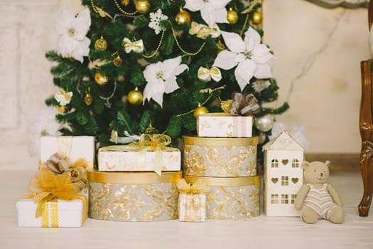 New Year's and Christmas interior in gold color with  a fir-tree and gifts