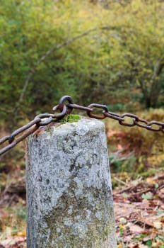 one stone with a rusty chain to next stone