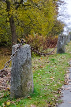 one rusty chain betwen two old stone