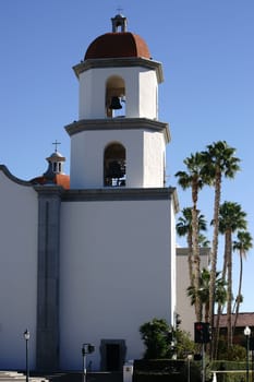 San Juan Capistrano,United States - December 25,2015: A bell tower of the Mission Basilica of San Juan Capistrano with palm trees on December 25,2015 in San Juan Capistrano.