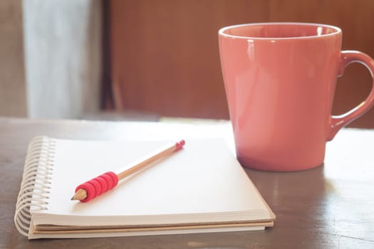 Blank notebook with pencil on grey background, business concept